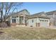 Inviting single-Gathering home featuring a classic design, tidy front yard, and a convenient two-car garage at 6508 Moss Cir, Arvada, CO 80007