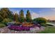 Lush flowerbed features colorful blooms, decorative rocks, and manicured greenery, adding to the property's curb appeal at 6508 Moss Cir, Arvada, CO 80007