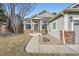 Well-maintained home showcasing a tidy front yard and brick-accented entrance with inviting curb appeal at 6508 Moss Cir, Arvada, CO 80007