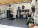 Organized garage with cabinets, workbench, epoxy flooring, and overhead storage at 6508 Moss Cir, Arvada, CO 80007