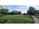 Sprawling community green space with mature trees and sidewalk at 6508 Moss Cir, Arvada, CO 80007