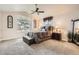 Comfortable bedroom featuring a ceiling fan, large windows, carpet and a decorative bench at 6508 Moss Cir, Arvada, CO 80007