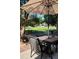 Outdoor patio area with comfortable seating under a large umbrella overlooking a lush green lawn at 6508 Moss Cir, Arvada, CO 80007