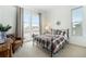 Well-lit bedroom features a comfortable bed, large windows, and neutral decor at 7202 Canyonpoint Rd, Castle Pines, CO 80108