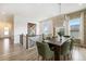 Spacious dining area features modern chandelier, neutral walls and window, perfect for hosting gatherings at 7202 Canyonpoint Rd, Castle Pines, CO 80108