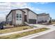 Charming two-story home featuring stone accents, siding, a well-manicured lawn, and a two-car garage at 7202 Canyonpoint Rd, Castle Pines, CO 80108