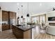 Bright open floor plan, stainless steel appliances, kitchen island, dining area and living room, ideal for gatherings at 7202 Canyonpoint Rd, Castle Pines, CO 80108