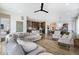 Bright and open floor plan connecting the kitchen, dining, and living areas, perfect for entertaining at 7202 Canyonpoint Rd, Castle Pines, CO 80108