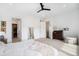 Spacious main bedroom boasts neutral palette, fan, and ample storage space creating a calming sanctuary at 7202 Canyonpoint Rd, Castle Pines, CO 80108