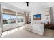 Bright main bedroom with large windows, neutral decor, and comfortable king bed provides a serene retreat at 7202 Canyonpoint Rd, Castle Pines, CO 80108