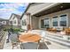 Inviting outdoor patio area with comfortable seating, a dining table, and string lights for ambiance at 7202 Canyonpoint Rd, Castle Pines, CO 80108