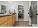 Well-lit bathroom featuring a double vanity, walk-in shower, and open access to the closet at 18108 E 52Nd Ave, Denver, CO 80249