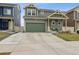 Two-story home with a gray exterior, green accents, and a spacious two-car attached garage at 18108 E 52Nd Ave, Denver, CO 80249