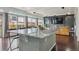 Modern kitchen island with a granite countertop and seating, opening to a sunny living room and outdoor deck at 18108 E 52Nd Ave, Denver, CO 80249