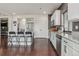 Kitchen with stainless steel appliances, sleek countertops, a center island with seating, and hardwood floors at 18108 E 52Nd Ave, Denver, CO 80249