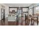 Modern kitchen featuring stainless steel appliances, sleek countertops, a dining area, and hardwood floors at 18108 E 52Nd Ave, Denver, CO 80249