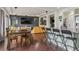 Open-concept dining and kitchen area with hardwood floors and stylish furnishings at 18108 E 52Nd Ave, Denver, CO 80249