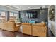 Relaxing living room featuring a large TV, designer accent wall, and comfortable corduroy furniture at 18108 E 52Nd Ave, Denver, CO 80249