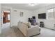 Bright room with plush sofa, workspace, and door leading to another room at 18108 E 52Nd Ave, Denver, CO 80249