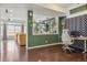 Comfortable living room featuring hardwood floors, decorative room divider, and bright natural light from windows at 18108 E 52Nd Ave, Denver, CO 80249
