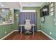 Home office with hardwood flooring, designer paint and dark patterned curtain at 18108 E 52Nd Ave, Denver, CO 80249