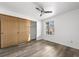Bedroom with wood sliding doors to closet and hardwood floor at 7820 W 87Th Dr # K, Arvada, CO 80005