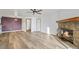 Open living room with hardwood floors, fireplace, and access to dining area at 7820 W 87Th Dr # K, Arvada, CO 80005
