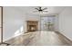 Living room with hardwood floors, fireplace, and sliding door access at 7820 W 87Th Dr # K, Arvada, CO 80005