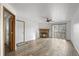 Bright living room featuring hardwood floors and a stone fireplace at 7820 W 87Th Dr # K, Arvada, CO 80005