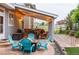 Back patio with a fire pit and colorful Adirondack chairs at 3902 Eagle Tail Ln, Castle Rock, CO 80104
