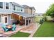 Backyard featuring a covered patio, stone walkway, and lush greenery at 3902 Eagle Tail Ln, Castle Rock, CO 80104