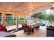 Covered patio with outdoor seating and a grill, perfect for entertaining at 3902 Eagle Tail Ln, Castle Rock, CO 80104