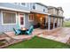 Outdoor patio area featuring a fire pit, stylish chairs, and a covered patio with string lights for relaxing evenings at 3902 Eagle Tail Ln, Castle Rock, CO 80104