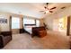 Spacious bedroom featuring a ceiling fan, large windows, and cozy carpeting at 3902 Eagle Tail Ln, Castle Rock, CO 80104