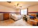Bright bedroom features neutral carpet, ceiling fan, and large window perfect for natural light at 3902 Eagle Tail Ln, Castle Rock, CO 80104