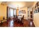 Formal dining room with hardwood floors, elegant chandelier, and large windows providing natural light at 3902 Eagle Tail Ln, Castle Rock, CO 80104