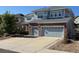 Attractive two-story home featuring a brick facade and attached two-car garage, with a driveway at 3902 Eagle Tail Ln, Castle Rock, CO 80104