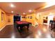 Finished basement game room features a pool table, hardwood floors, recessed lighting, and wet bar at 3902 Eagle Tail Ln, Castle Rock, CO 80104