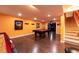 Finished basement game room features a pool table, hardwood floors, recessed lighting, and wet bar at 3902 Eagle Tail Ln, Castle Rock, CO 80104