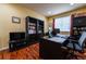 Functional home office with built-in bookshelves, a large desk, and ample lighting for productivity at 3902 Eagle Tail Ln, Castle Rock, CO 80104
