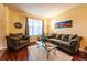 Cozy living room with comfortable seating, a large window, and a plush rug for a welcoming atmosphere at 3902 Eagle Tail Ln, Castle Rock, CO 80104