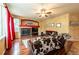 Comfortable living room featuring a fireplace, ceiling fan, and warm decor at 3902 Eagle Tail Ln, Castle Rock, CO 80104