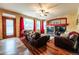 Bright living room with hardwood floors, fireplace, and large windows at 3902 Eagle Tail Ln, Castle Rock, CO 80104