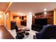 Finished basement media room with flat screen TV, wet bar, modern lighting, and luxury seating at 3902 Eagle Tail Ln, Castle Rock, CO 80104