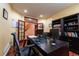 Spacious home office with built-in shelves, desk, and monitors, plus a glass door view to the home's interior at 3902 Eagle Tail Ln, Castle Rock, CO 80104