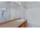 Well-lit bathroom featuring a shower-tub combo with white tile and modern fixtures at 10715 Twenty Mile Rd # 203, Parker, CO 80134