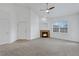 Inviting living room with a cozy fireplace and a ceiling fan at 10715 Twenty Mile Rd # 203, Parker, CO 80134