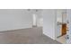 Bright living room featuring neutral carpet and white walls at 10715 Twenty Mile Rd # 203, Parker, CO 80134