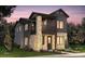 Modern two-story home boasts stone accents, dark siding, a small porch, and a well-manicured lawn at 8635 Hotchkiss St, Littleton, CO 80125