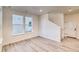Bright living room with wood floors, recessed lighting, and large windows offering natural light and views at 8635 Hotchkiss St, Littleton, CO 80125